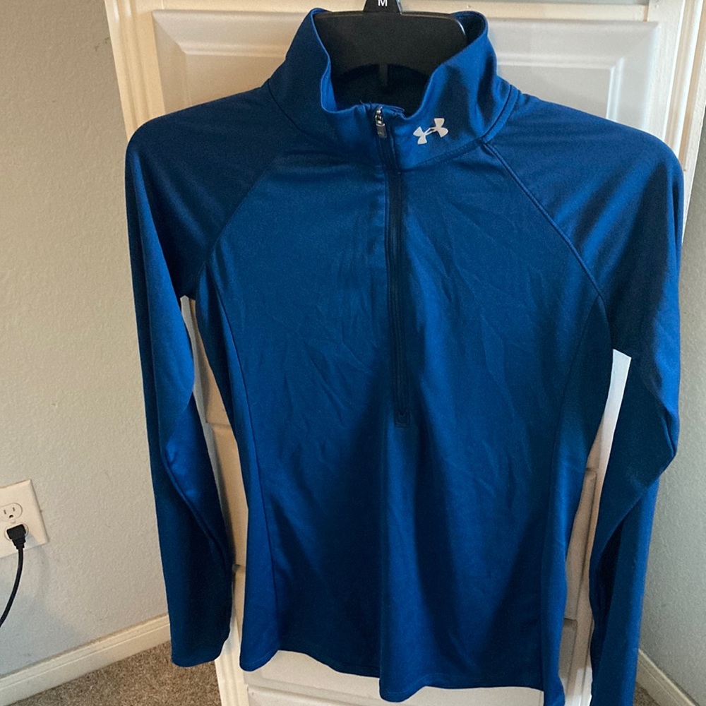 Under armor, navy blue with silver emblem, long sleeve top.